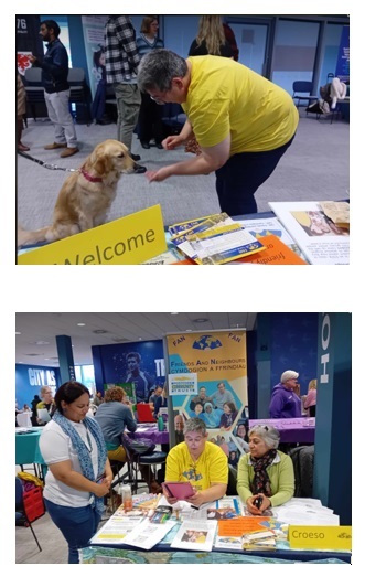 Photos of Ruth and dog plus vols on stall with Postcode Lottery logo in background.